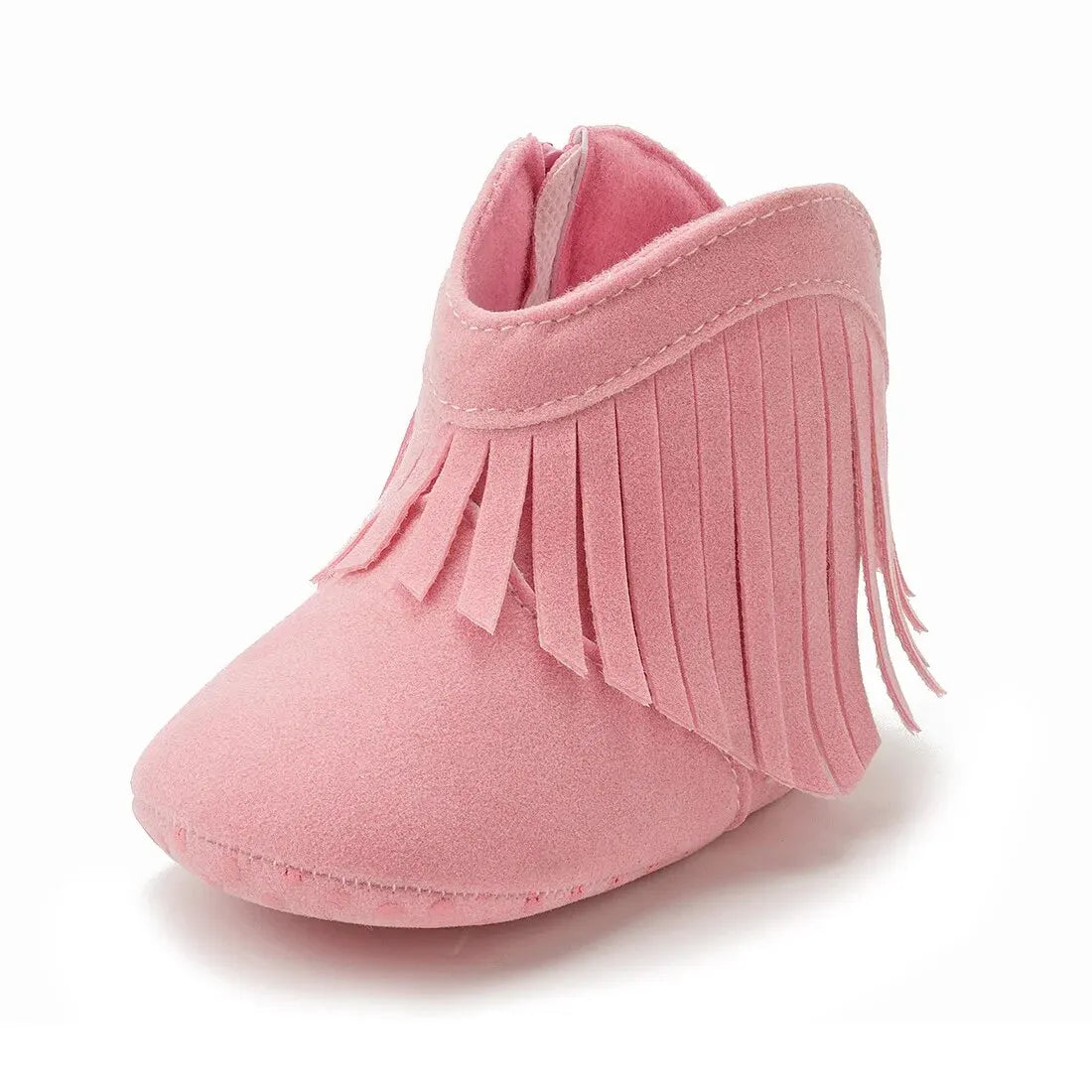 Studio side profile view of a pink infant fringe suede moccasin bootie on a white background.