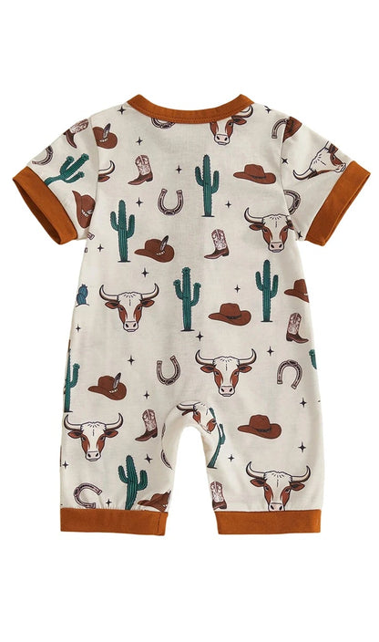 Back view of a cream infant short sleeve zip-up romper with a western longhorn skull, cactus, and horseshoe pattern.
