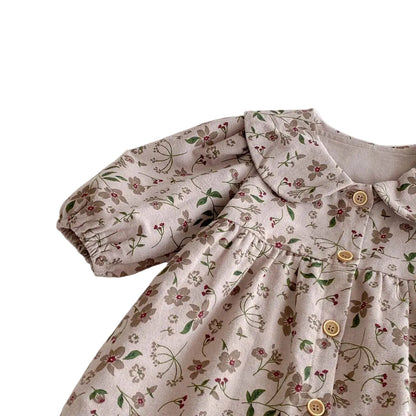 Close-up of the shoulder seam and balloon sleeve detailing on the Kidsely floral baby jumpsuit.