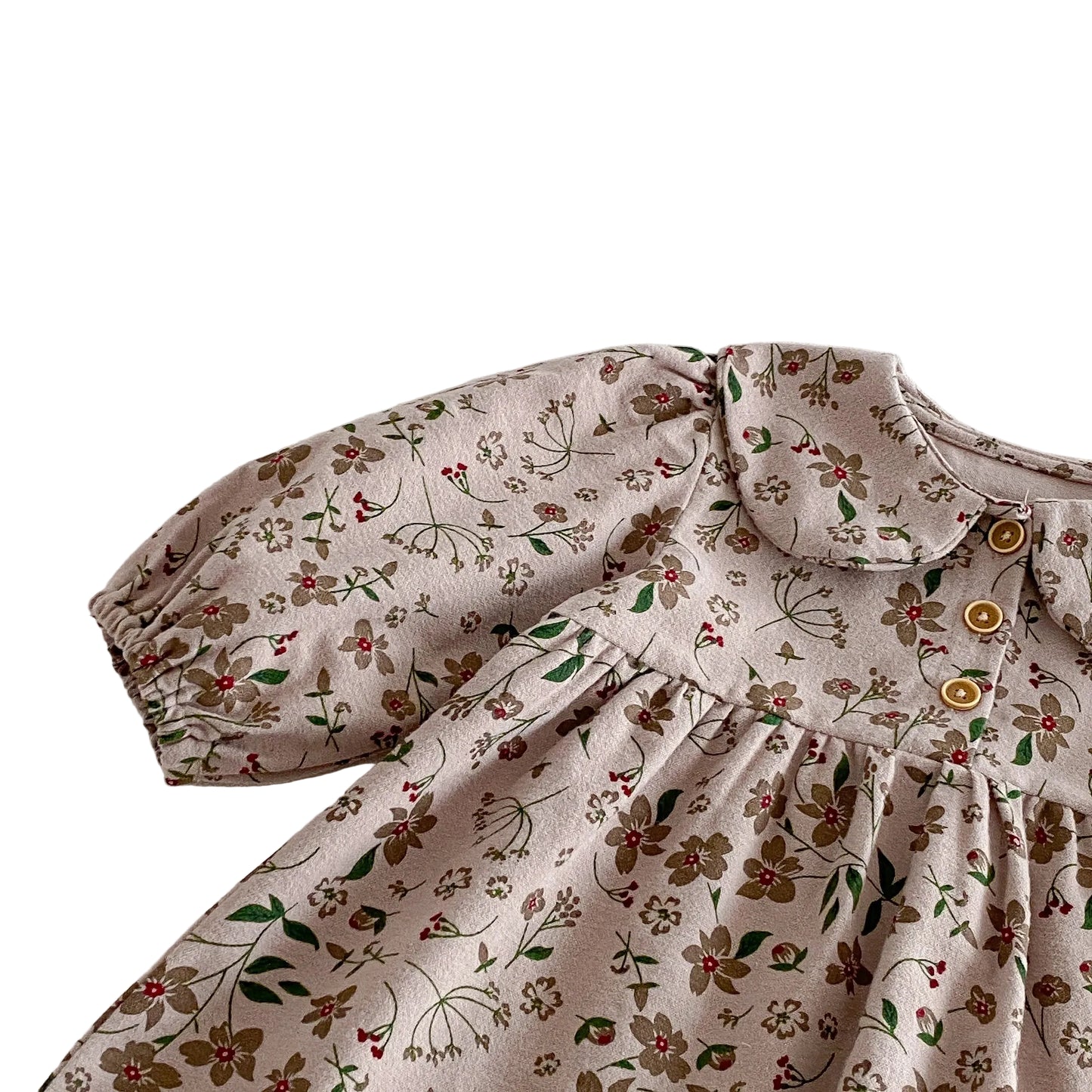 Close-up showing the gently gathered shoulder seam and full long sleeve on the vintage mauve floral dress.