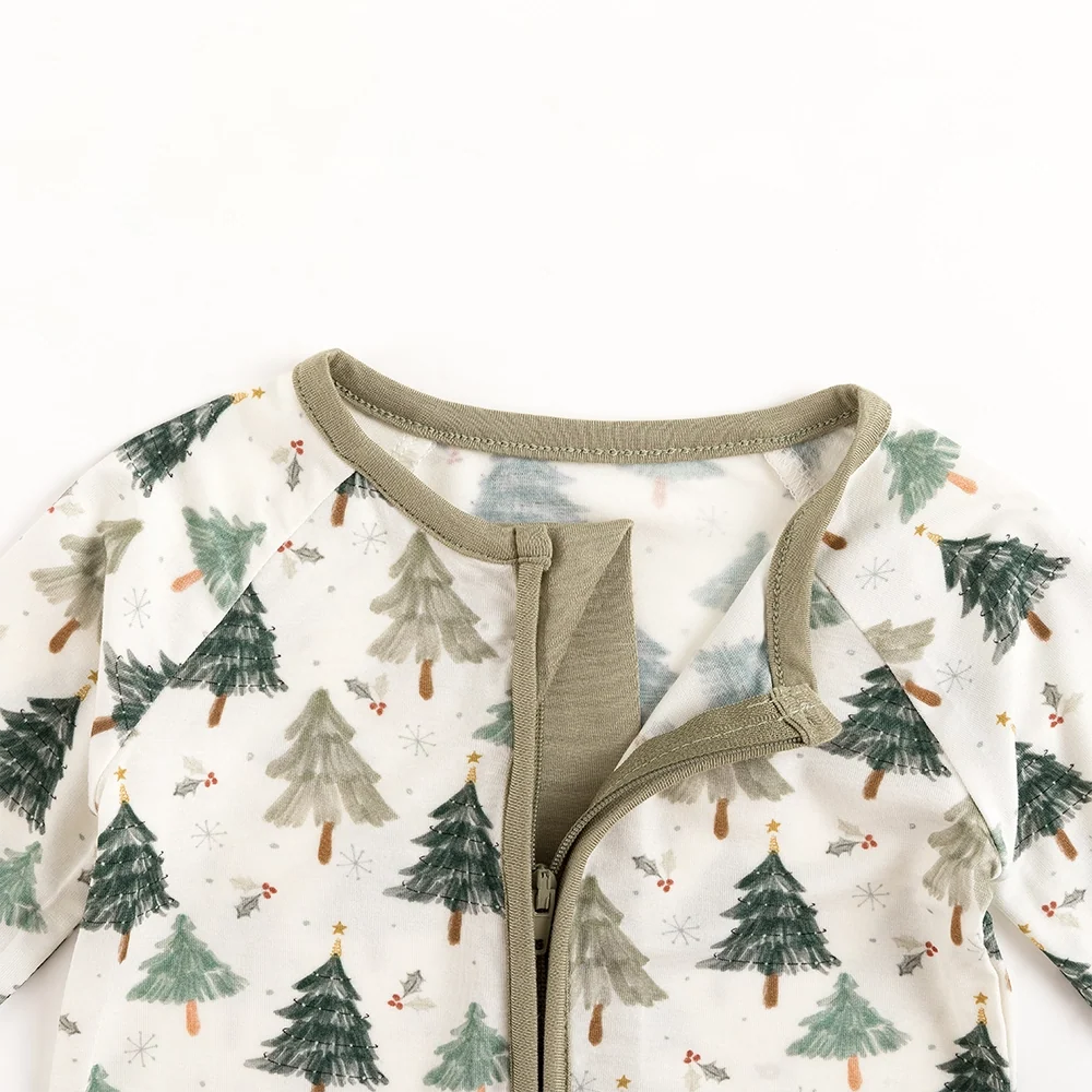 Detail of open interior zipper guard fabric tab on Kidsely evergreen Christmas tree bamboo zipper romper