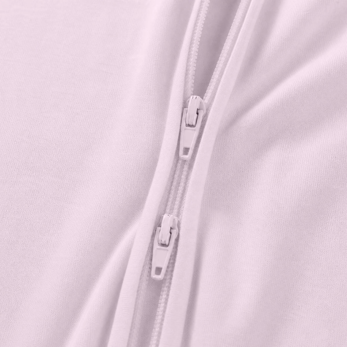 Close-up detail of smooth 2-way dual zipper on Kidsely solid light pink bamboo viscose baby sleeper