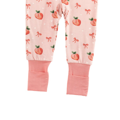 Detail view of pink fold-over convertible footie cuffs on Kidsely sweet peach and bow print bamboo romper