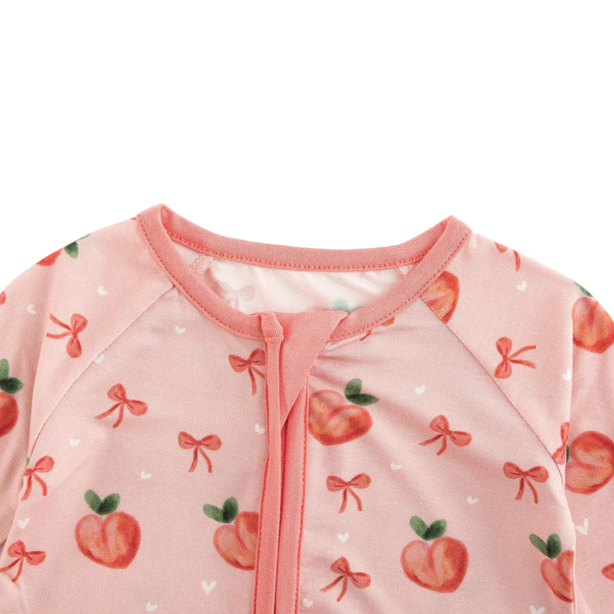 Close-up view of protective fabric zipper guard at neckline on Kidsely sweet peach bamboo baby sleeper