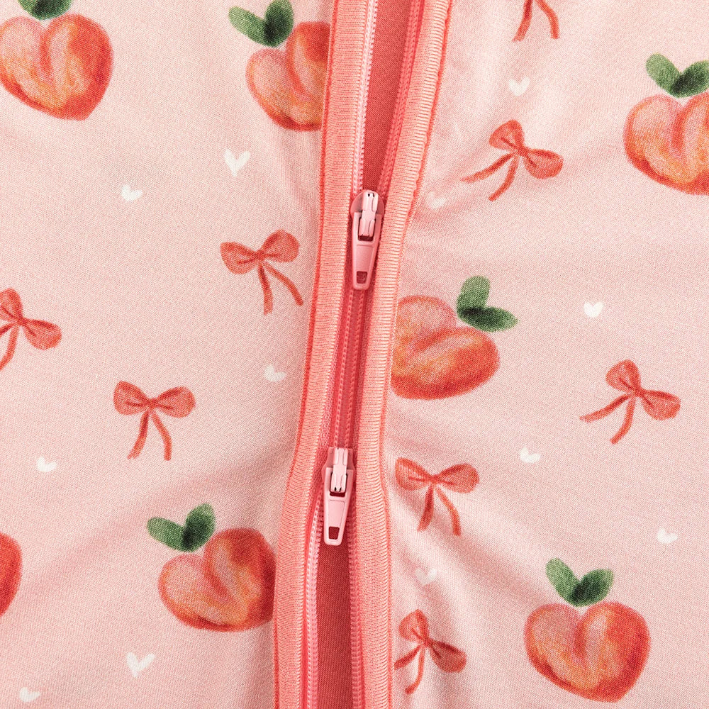 Close-up detail of smooth 2-way dual zipper on Kidsely sweet peach and bow print bamboo baby sleeper