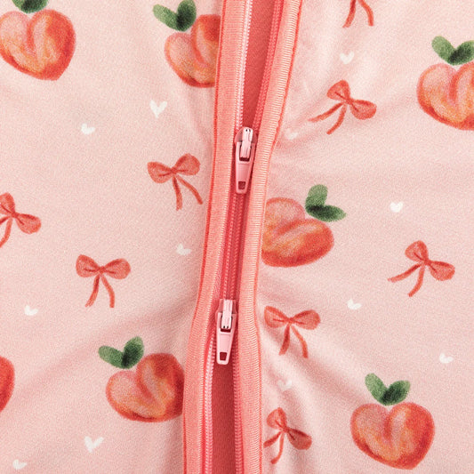 Close-up detail of smooth 2-way dual zipper on Kidsely sweet peach and bow print bamboo baby sleeper