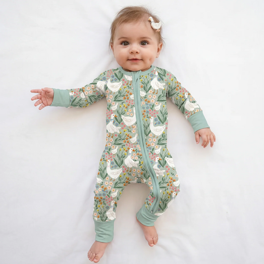 Baby model wearing Kidsely daisy goose floral bamboo viscose zipper romper sleeper on white background