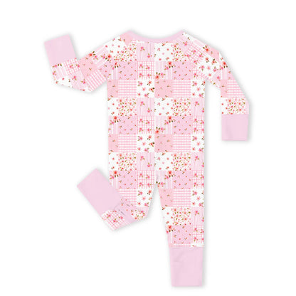 Full back flat lay view of Kidsely bamboo viscose baby girl zipper romper sleeper in pink floral quilt print