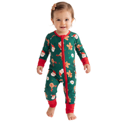 Baby model wearing Kidsely Santa and reindeer print bamboo viscose zipper romper sleeper with red cuffs