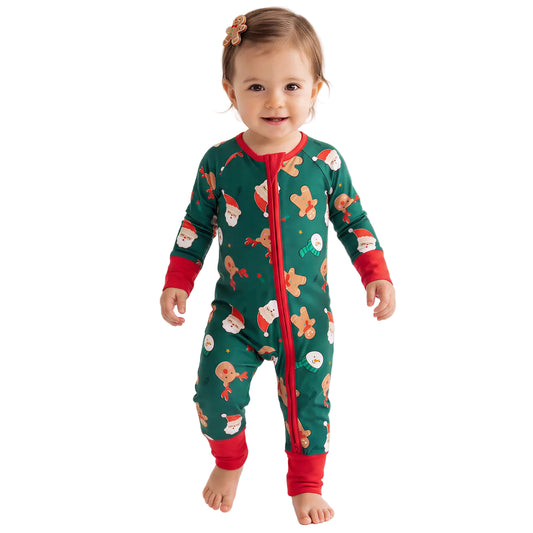 Baby model wearing Kidsely Santa and reindeer print bamboo viscose zipper romper sleeper with red cuffs