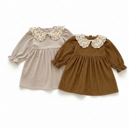 A beige and a warm brown ribbed corduroy toddler dress displayed side-by-side showing the floral collar details.