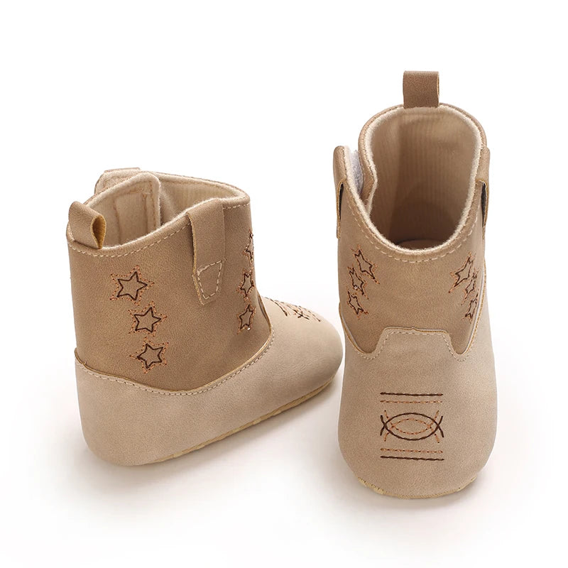 Two beige infant cowboy boots, one facing forward and one showing the back construction.