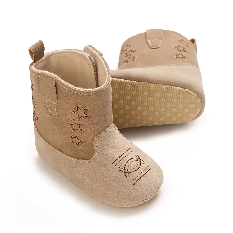 Side view of beige baby western boots highlighting the anti-slip grip soft sole and star details.