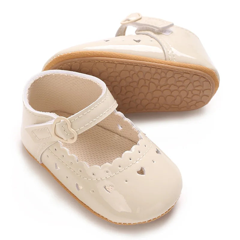 Side and bottom view of beige infant Mary Jane pre-walker shoe.