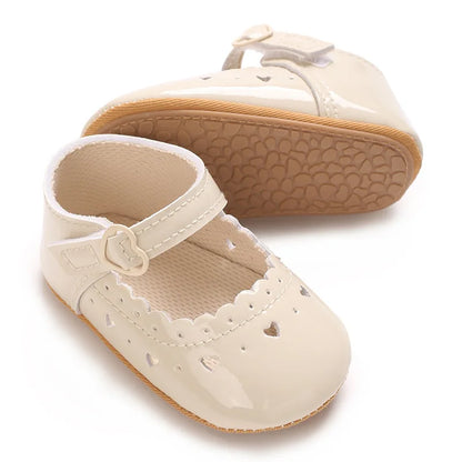 Side and bottom view of beige infant Mary Jane pre-walker shoe.