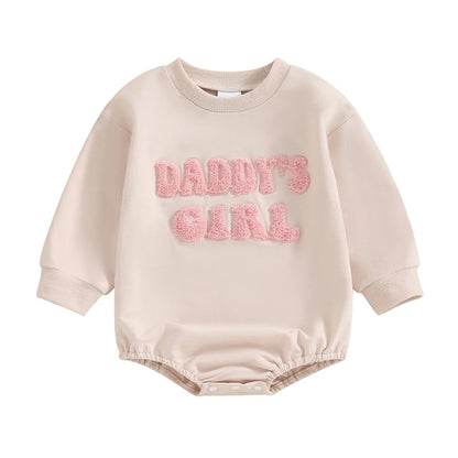 Beige Baby Girls "Daddy's Girl" long sleeve sweatshirt bubble romper with pink fuzzy letters on a white background.