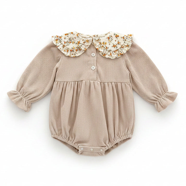 Back view of the beige ribbed corduroy baby romper showing the button closures at the back of the neck.