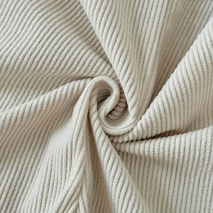 Macro close-up showing the soft, ribbed corduroy fabric texture of the Kidsely baby overalls in a neutral beige color.