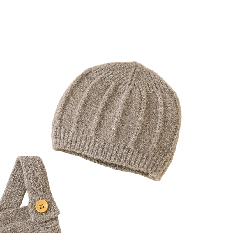 Close-up of the matching beige ribbed knit baby beanie hat, highlighting the stretchy texture.