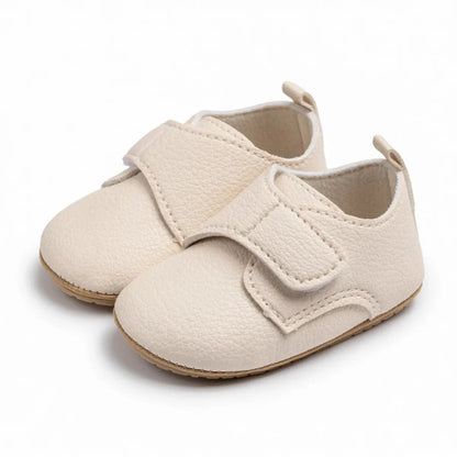 Pair of neutral beige toddler velcro loafers in a classic slip-on style.