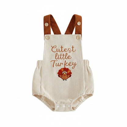 Front view of a beige baby corduroy bubble romper with brown straps and "Cutest little Turkey" embroidery.