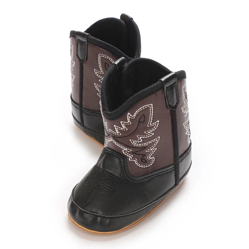 Pair of black and brown infant western boots standing upright.