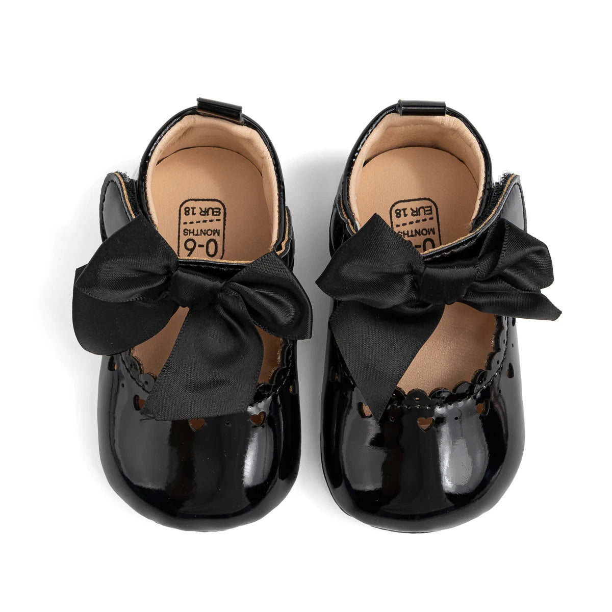Top-down view of black infant Mary Jane shoes showing the comfortable beige inner lining and size stamp.