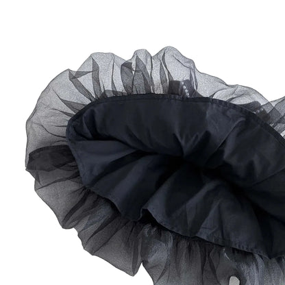 A view of the underside of the dress skirt, showing the smooth black inner lining that sits underneath the gathered tulle layers.