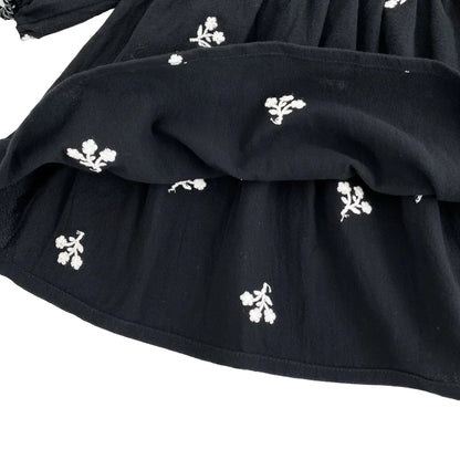 Close-up of the bottom hem and interior fabric of the black cotton blend toddler dress.