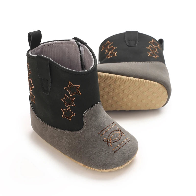 Side view of black and grey baby western boots highlighting the textured anti-slip soft sole.
