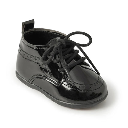 Main studio shot of a Kidsely single black high-gloss patent faux leather baby brogue oxford shoe with black laces on a clean white background.