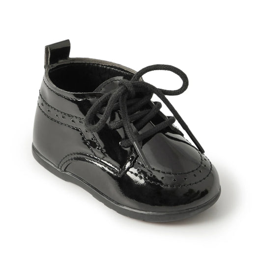 Main studio shot of a Kidsely single black high-gloss patent faux leather baby brogue oxford shoe with black laces on a clean white background.