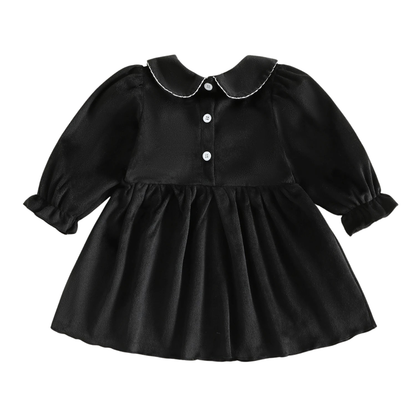 Back view of the black baby and toddler girls Halloween dress showing the Peter Pan collar detail and three white button closures down the back.
