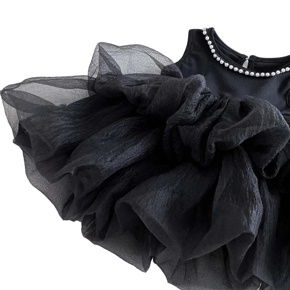 The black tiered tulle dress laid flat at an angle, showcasing the volume of the gathered ruffled skirt.