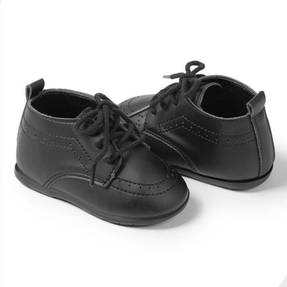 Side-by-side view of Kidsely black smooth faux leather toddler brogue oxfords with traditional black cotton shoelaces.