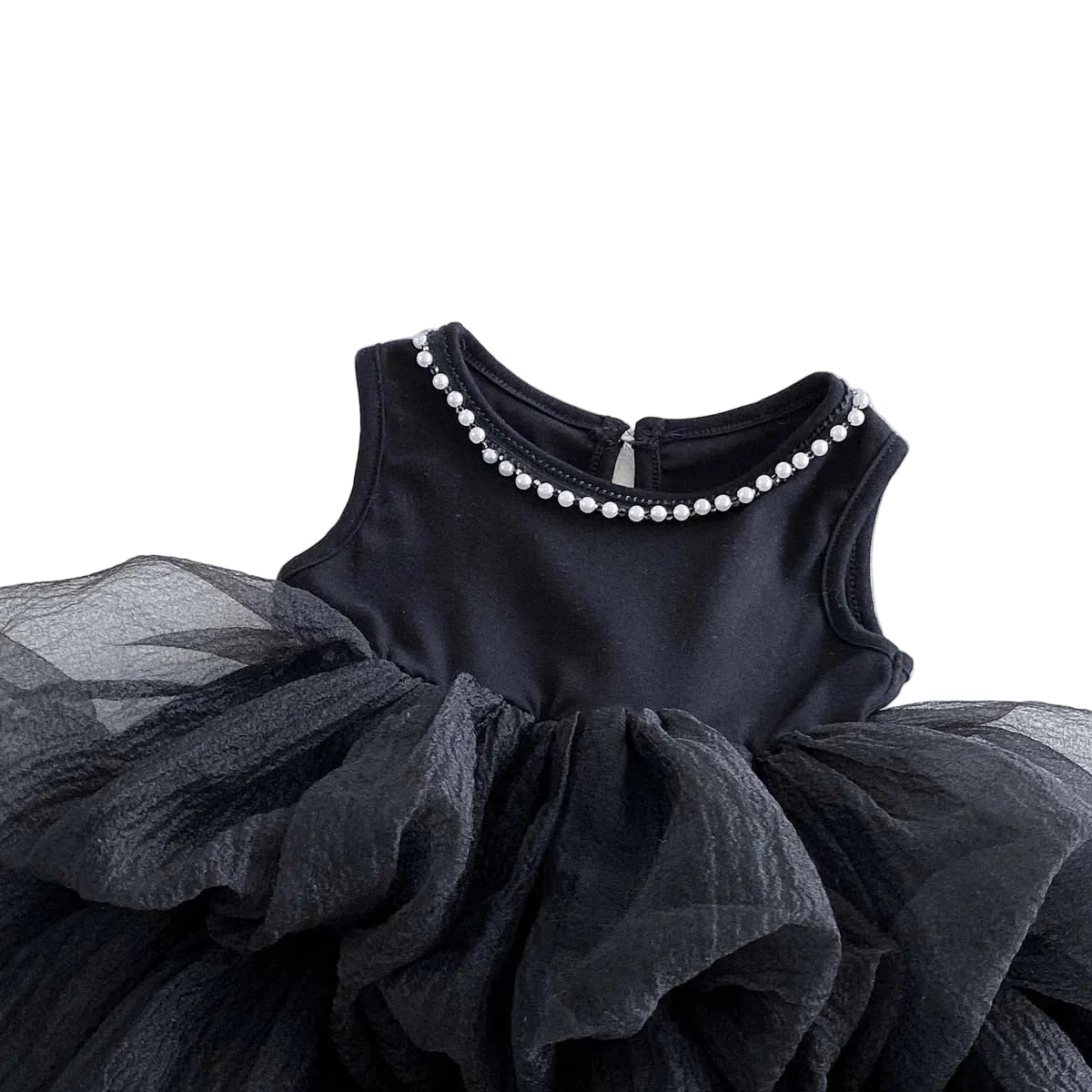 A high-resolution close-up focusing sharply on the single strand of pearl beads hand-stitched to the banded neckline of the black tulle dress.