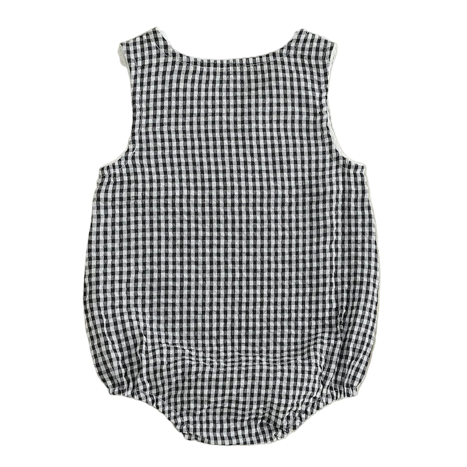 Full back view of the unisex black and white checkered seersucker baby bubble romper, highlighting the gathered elastic leg openings and relaxed bubble silhouette.