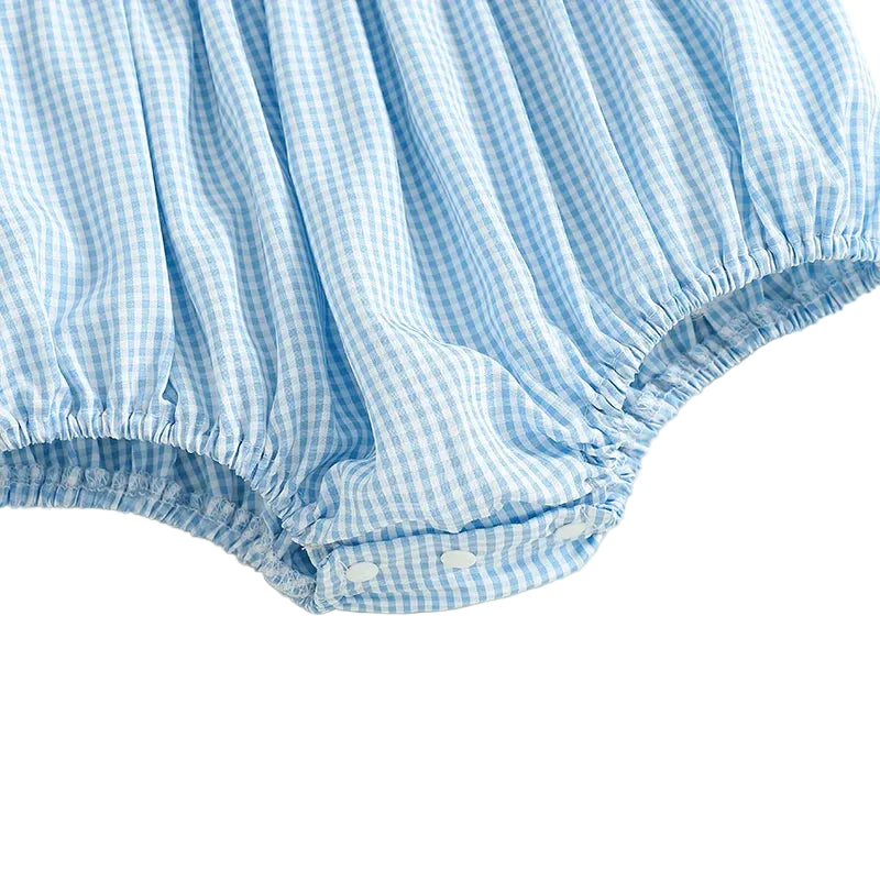 Close up of the bottom snap closures on the blue gingham baby bubble romper for easy diaper changes.