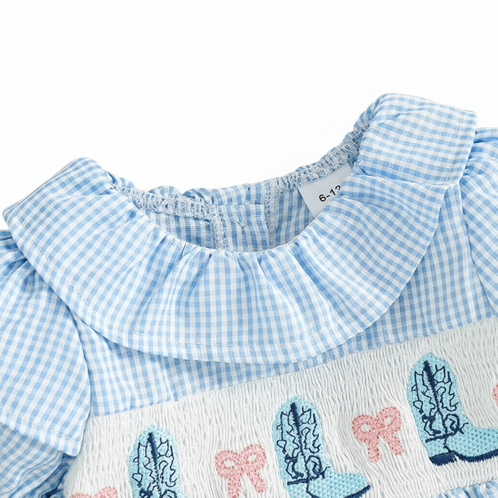 Close up of the ruffled round neck collar and smocking detail on the blue gingham baby jumpsuit.