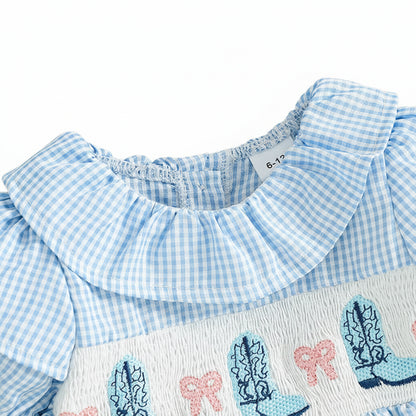 Close up of the ruffled round neck collar and smocking detail on the blue gingham baby jumpsuit.