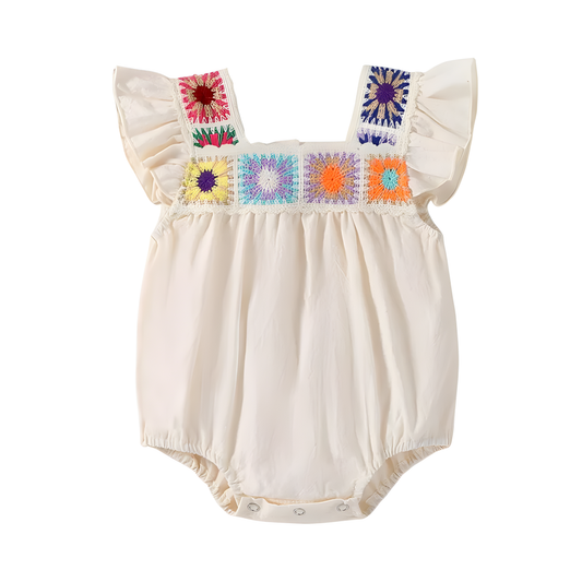Beige boho baby girl romper with multi-colored square crochet floral panels across the chest and ruffled fly sleeves.