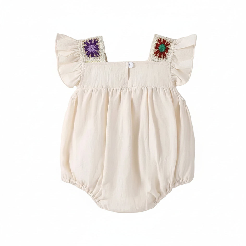 Full back view of the beige cotton baby bodysuit displaying the plain fabric back with colorful crochet shoulder accents.
