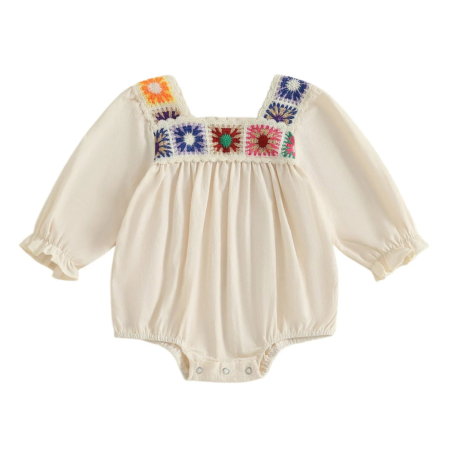 Beige long-sleeve boho baby girl romper featuring multi-colored square crochet floral panels across the chest and ruffled wrist cuffs against a white background.