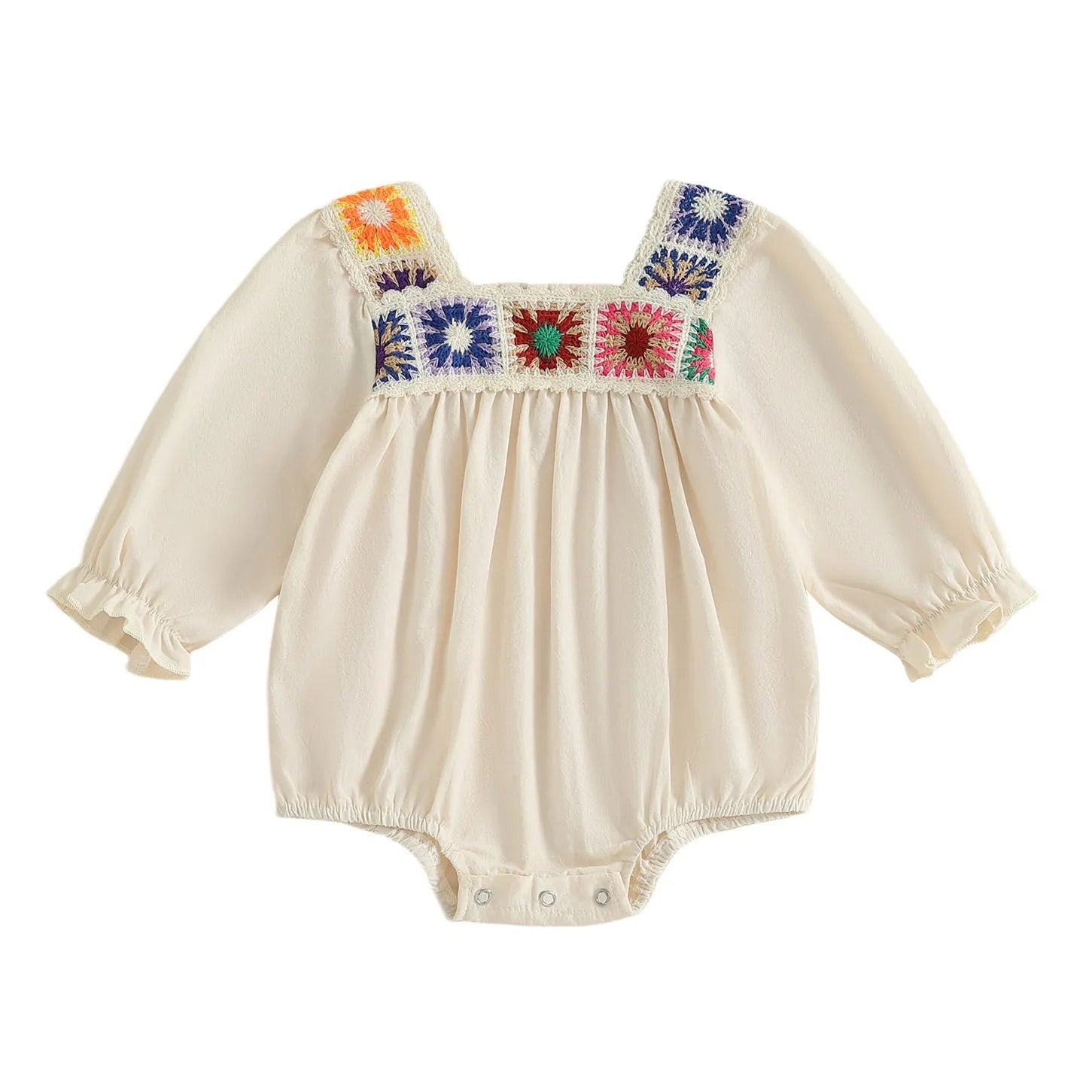 Beige long-sleeve boho baby girl romper featuring multi-colored square crochet floral panels across the chest and ruffled wrist cuffs against a white background.
