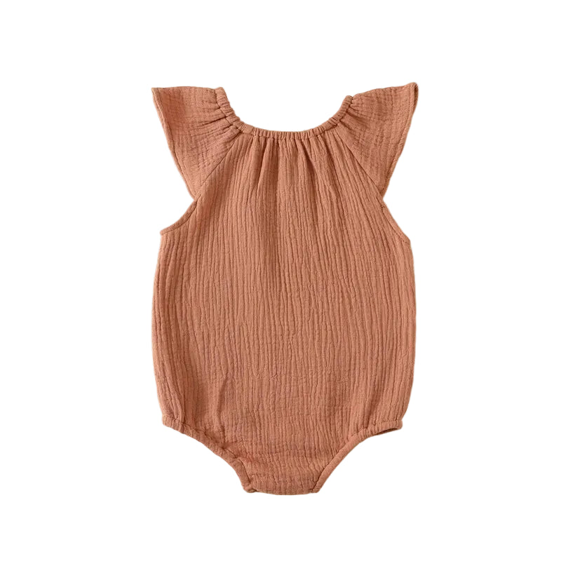 Back view flat lay of the terracotta rust baby girl muslin romper showing clean seams and comfortable fit.