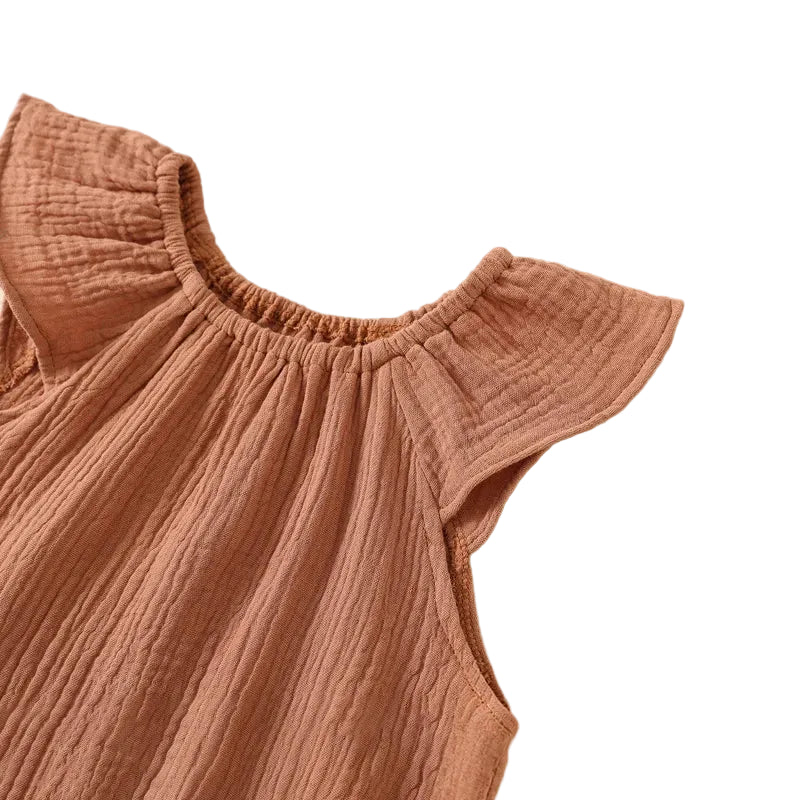 Macro view of the boutique quality double-stitching and gather details on the ruffle flutter sleeve of a terracotta baby sunsuit.