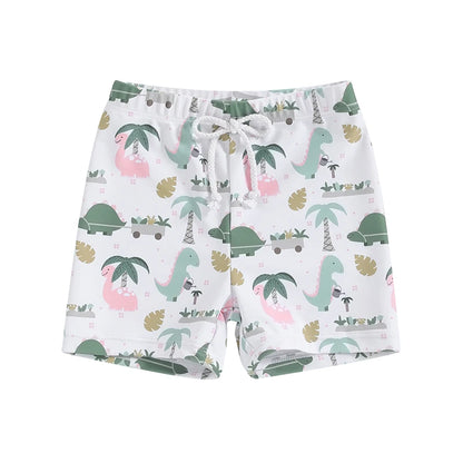 Little boys white swim trunks with a playful tropical dinosaur print featuring pink and green dinosaurs, palm trees, and gardening graphics.