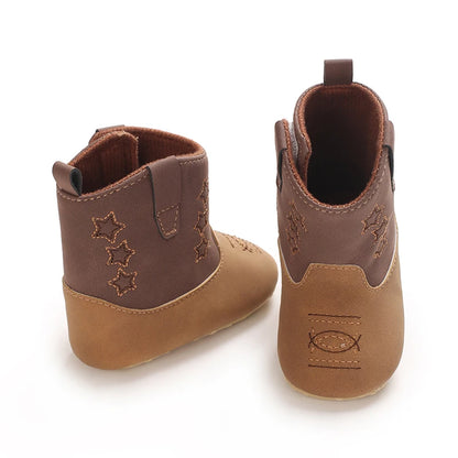 Two brown and tan infant cowboy boots, one facing forward to show toe stitching and one turned backward showing the heel and pull-tab.