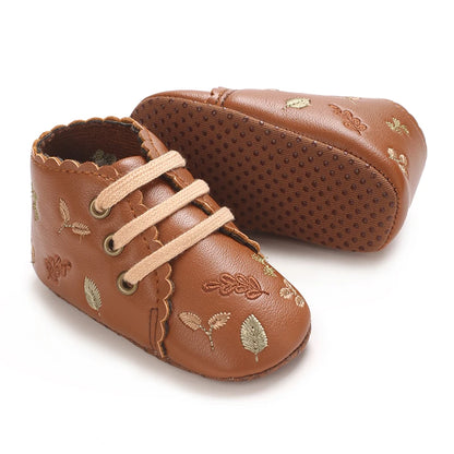Soft anti-slip sole on brown embroidered baby girl booties.