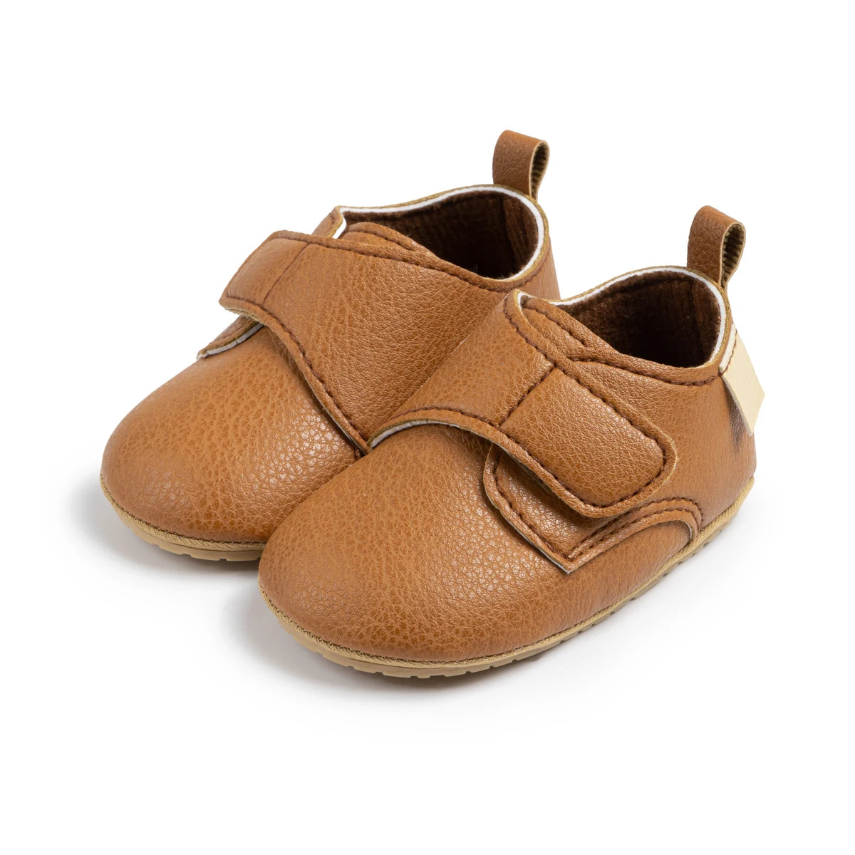 Pair of brown baby velcro loafers featuring a wide toe box and easy-on strap.